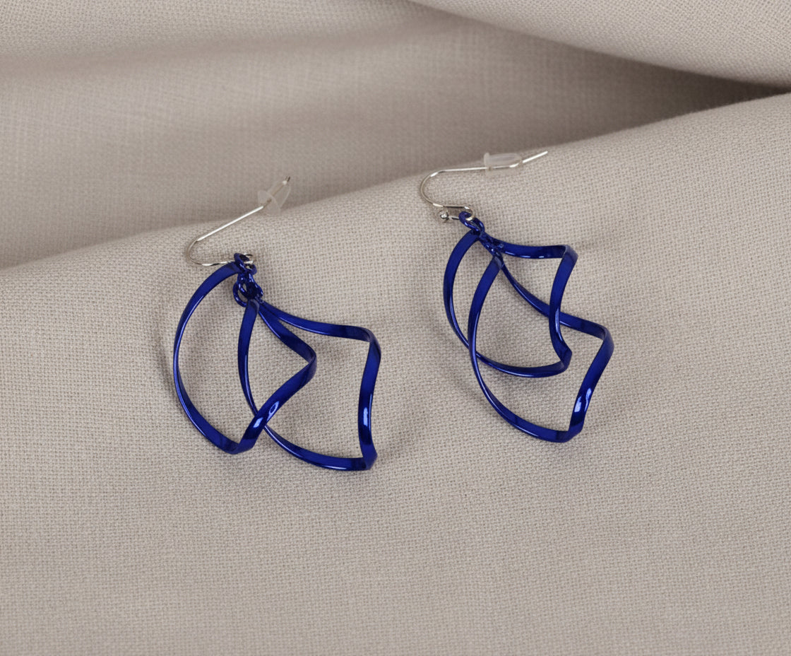 Blue wire earrings on a beige fabric background