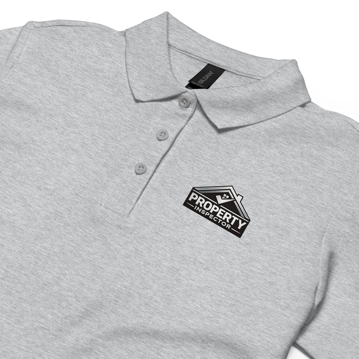 Close-up of the Property Inspector logo printed on a women’s sport grey polo work shirt.