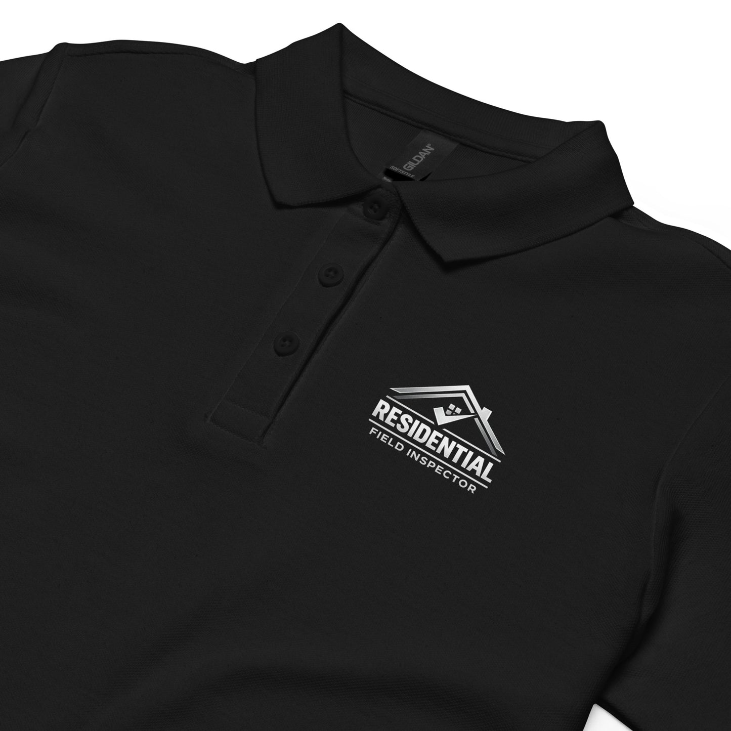 Close-up of residential field inspector logo on women’s polo shirt featuring house roofline design and professional text.