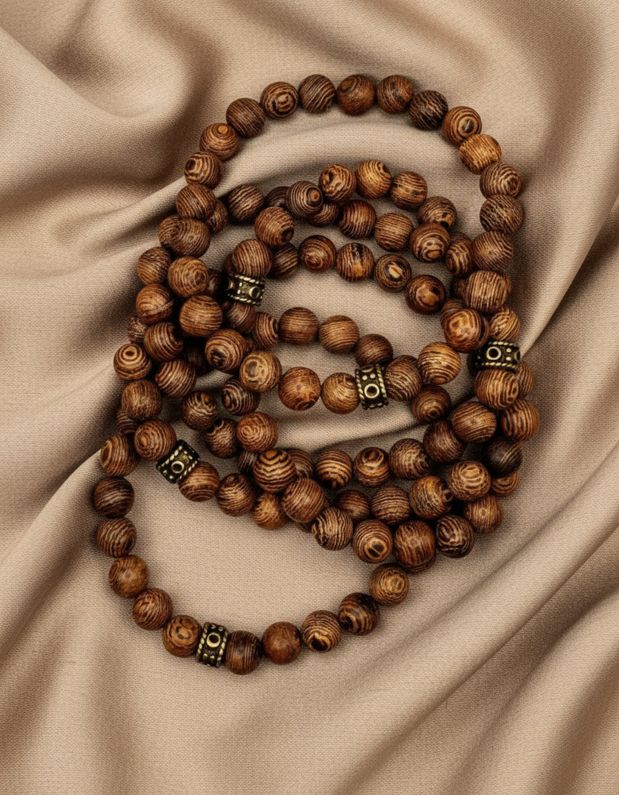 A dark brown natural wood stretch bracelet with antique vintage style spacers.