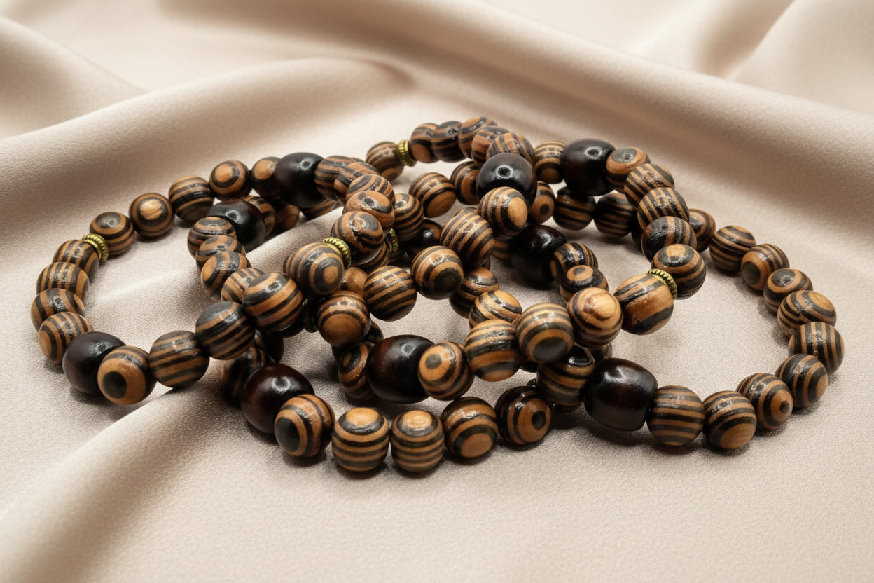 Wooden beaded necklace on a beige fabric background