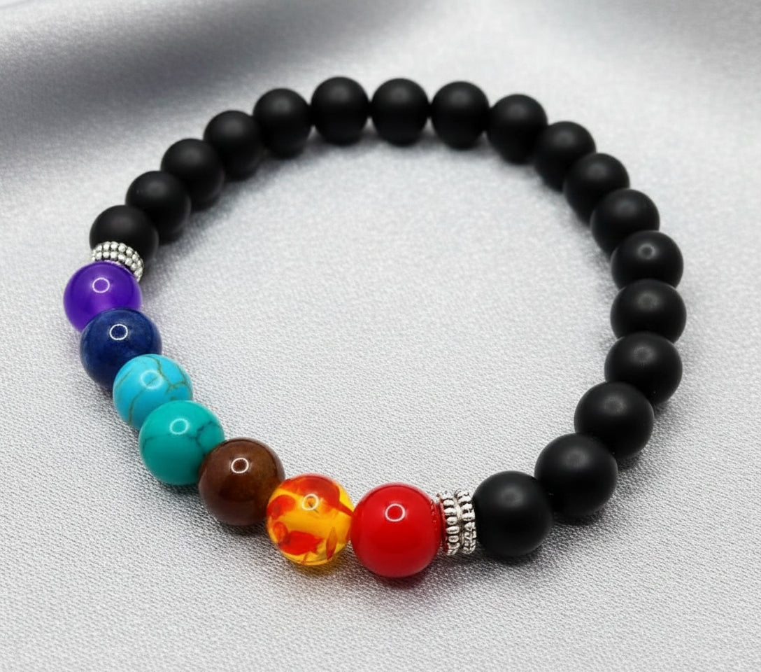 Black beaded bracelet with colorful focal beads on a gray background