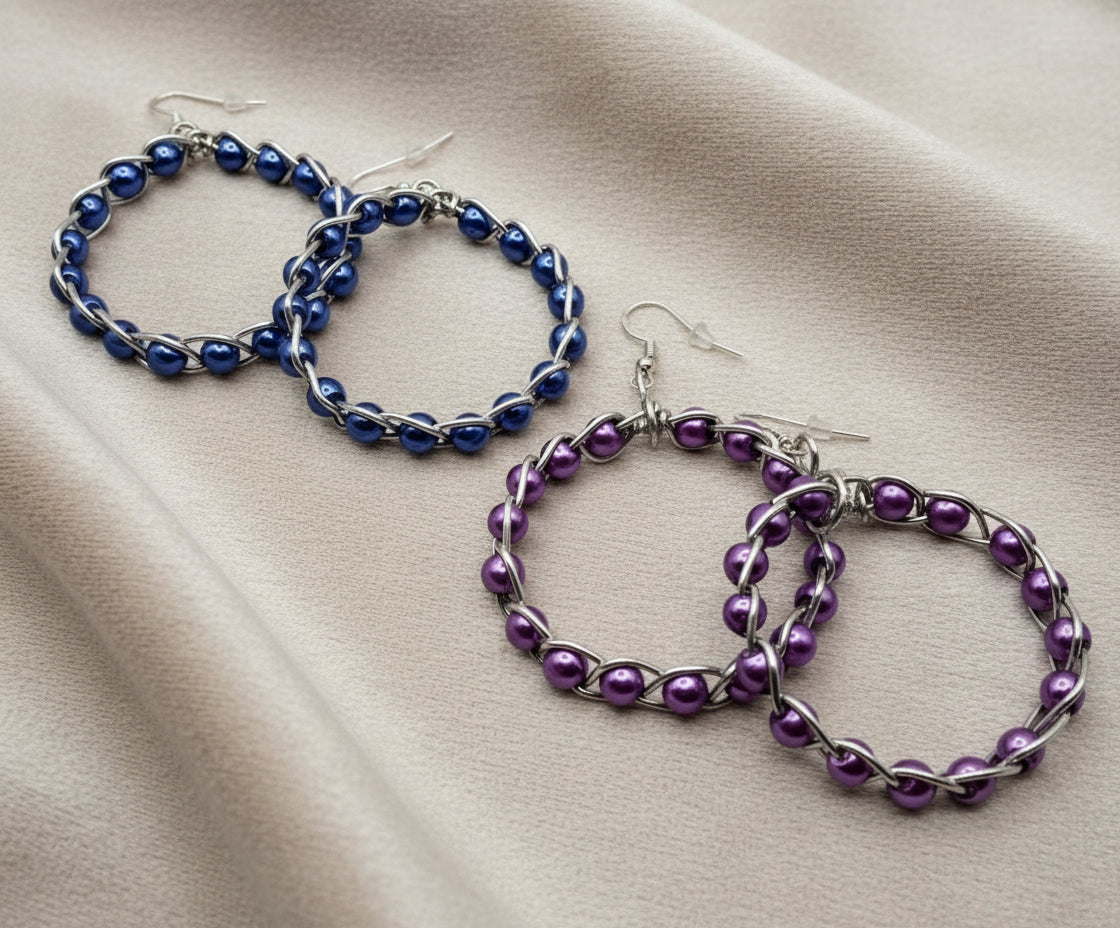 Close-up of handmade braided hoop earrings with colorful beads