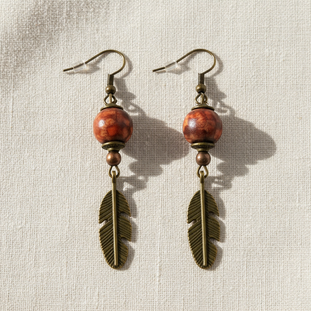Handmade wooden dreamcatcher earrings lying on a soft cloth