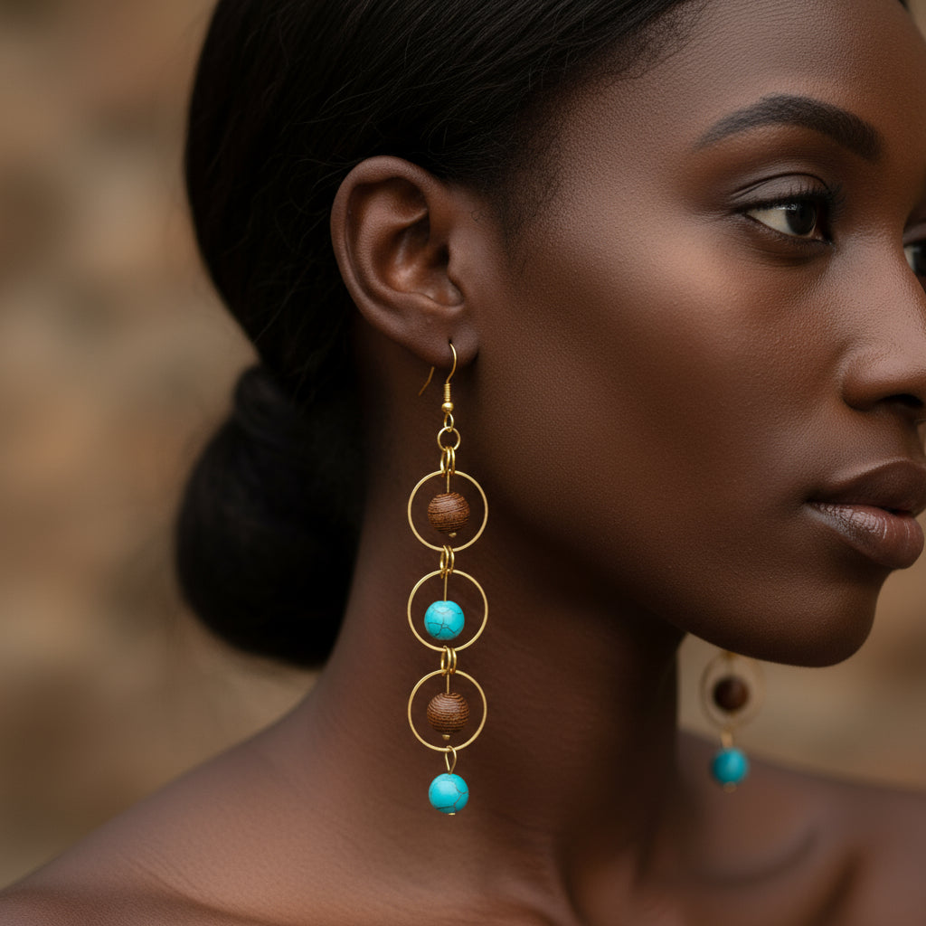 Close-up of three-layer gold hoop earrings with natural wood and turquoise, howlite, or chakra beads