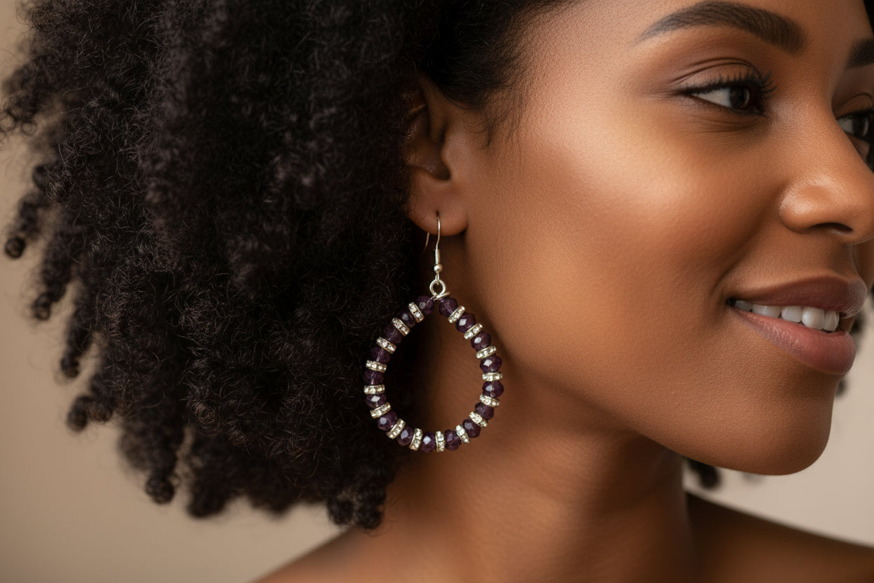 Close-up of a woman wearing a hoop earring with a neutral background