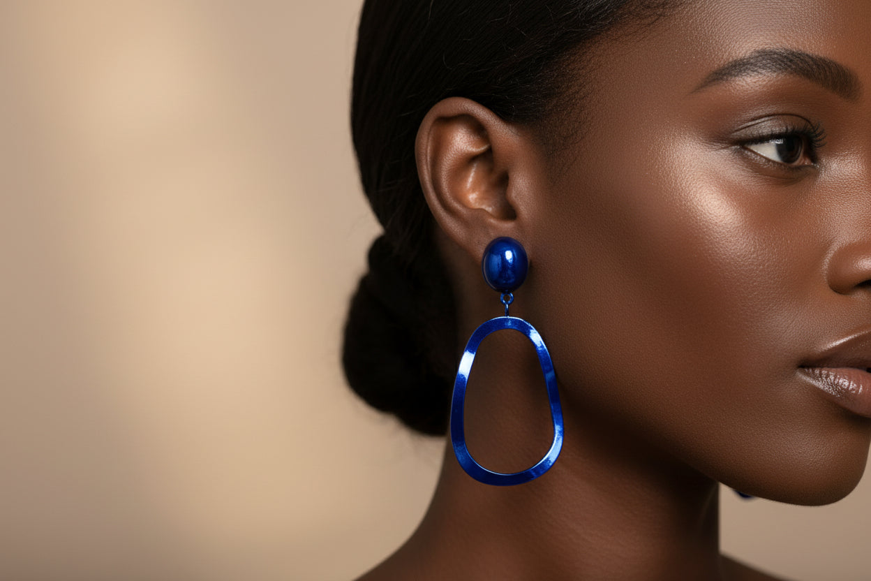 Close-up of a woman wearing a blue earring with a blurred background