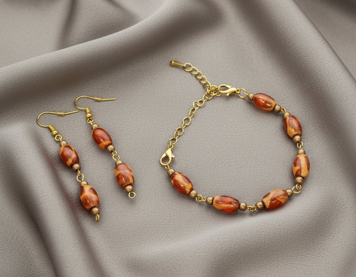Jewelry set with amber-colored beads on a white background