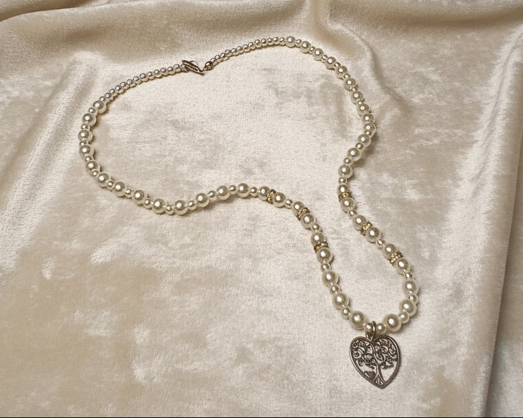 Necklace with a heart-shaped pendant on a white surface