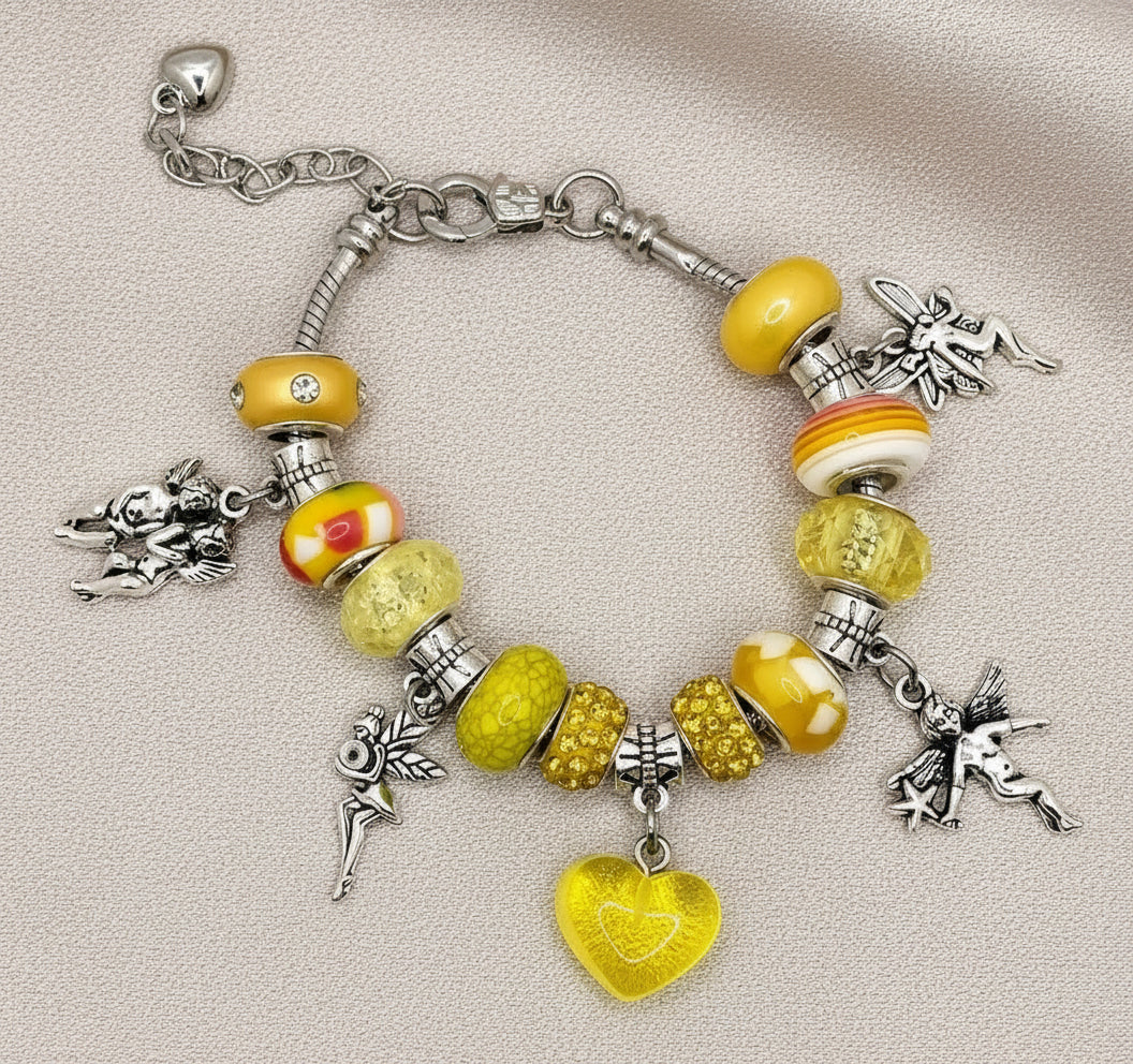 Bracelet with yellow beads and charms on a beige background