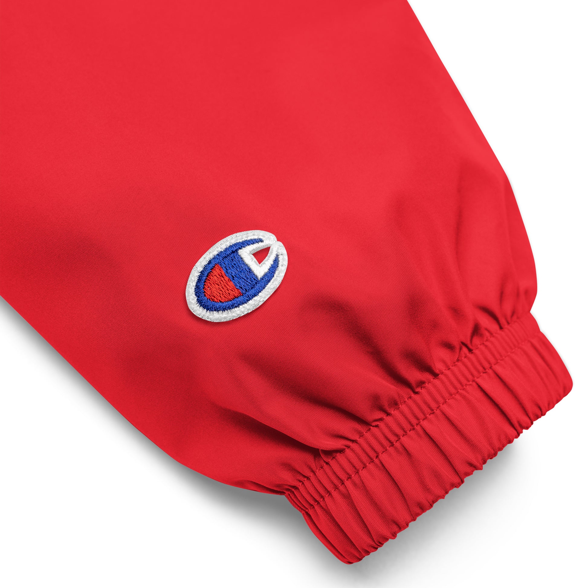 Close up of Champion packable work jacket sleeve with embroidered Champion logo
