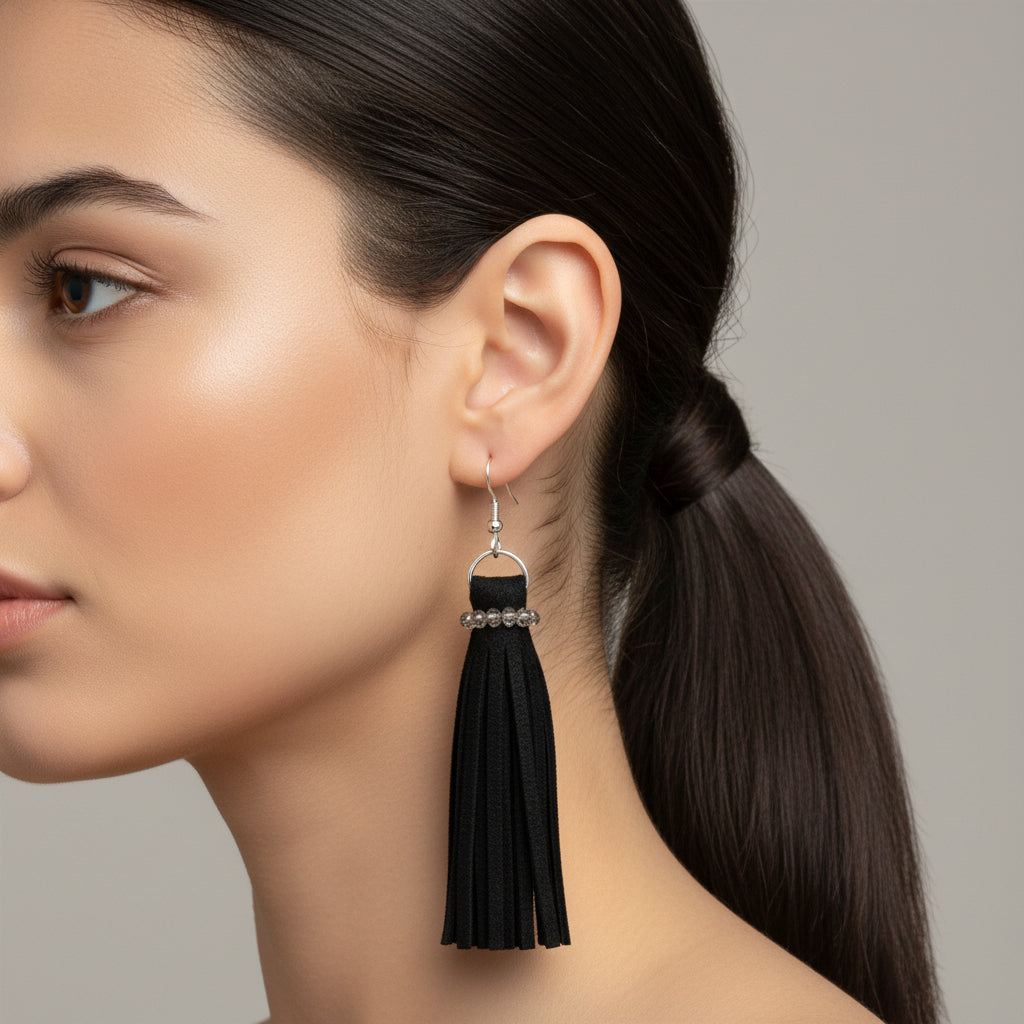 Black tassel earring on a model with a neutral background