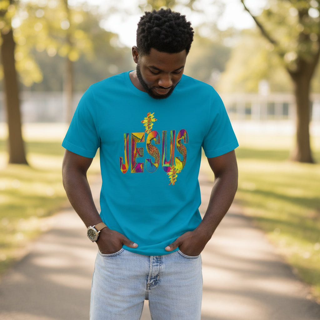 Man wearing a blue t-shirt with 'Jesus' printed in colorful letters outdoors.