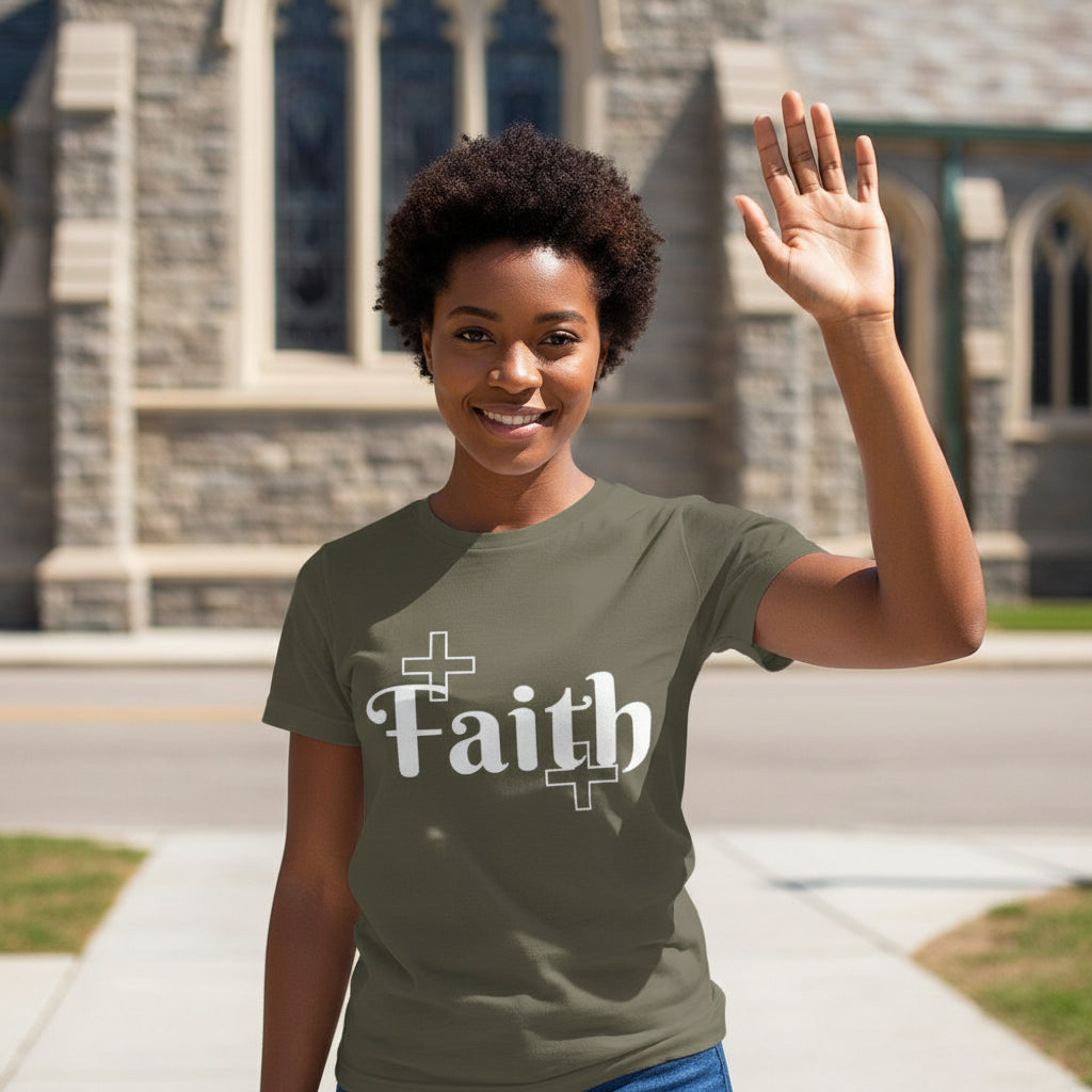 Woman wearing a green t-shirt with 'Faith' printed on it, waving in front of a stone building.