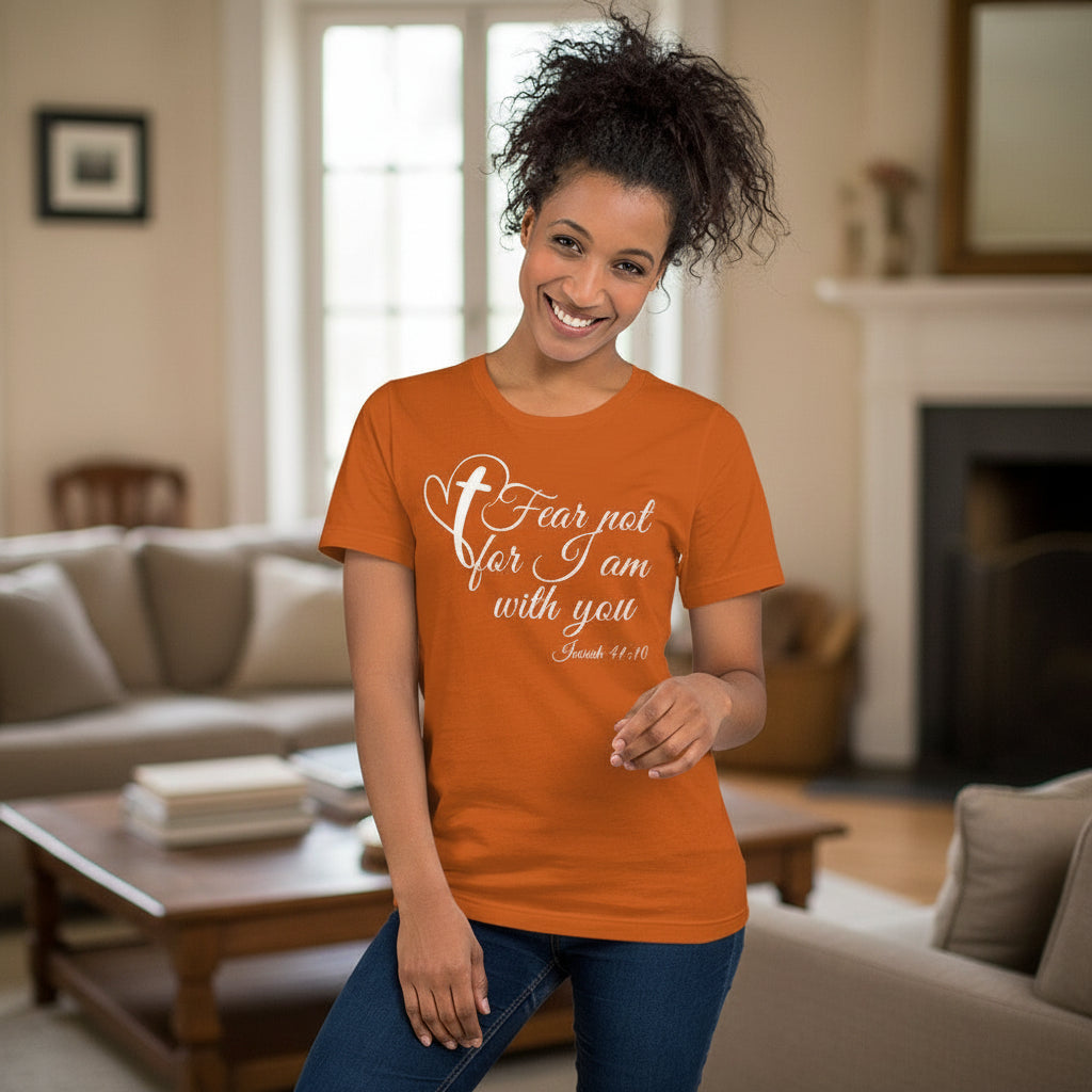 Woman wearing an orange t-shirt with a motivational quote in a living room.