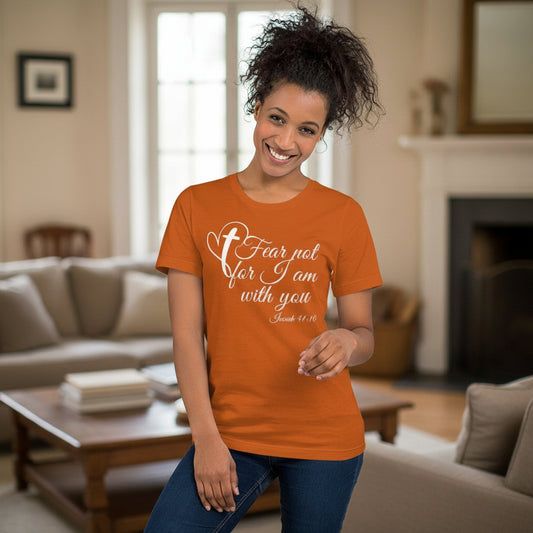 Woman wearing an orange t-shirt with a motivational quote in a living room.