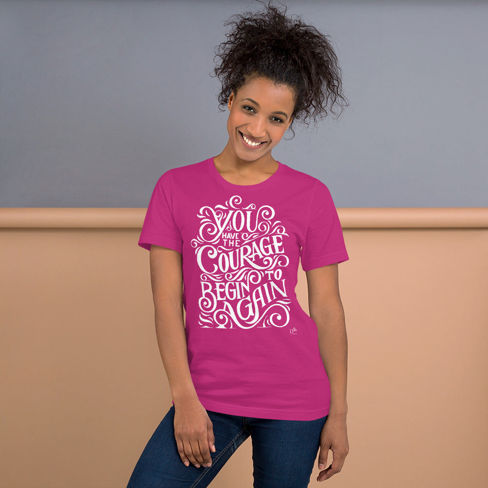 Woman wearing a pink t-shirt with motivational quote on a plain background