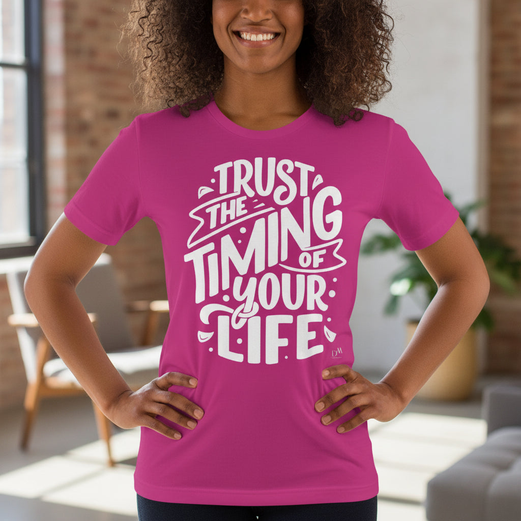 Person wearing a pink t-shirt with motivational text in a casual indoor setting