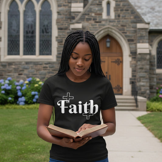 Woman wearing a black t-shirt with 'Faith' printed on it against a neutral background
