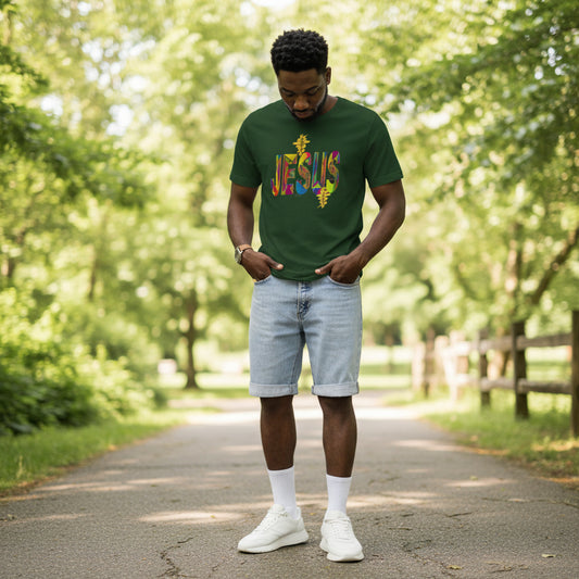 Man wearing a green t-shirt with colorful text standing in front of a brown backdrop