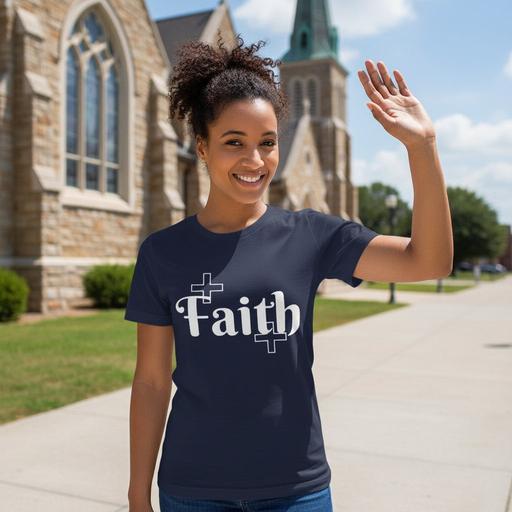 Woman wearing a navy blue t-shirt with 'Faith' printed on it, standing in front of a church.