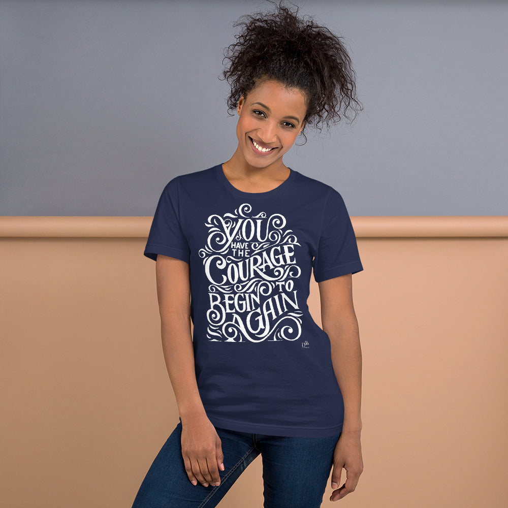 Woman wearing a navy blue t-shirt with motivational quote against a neutral background