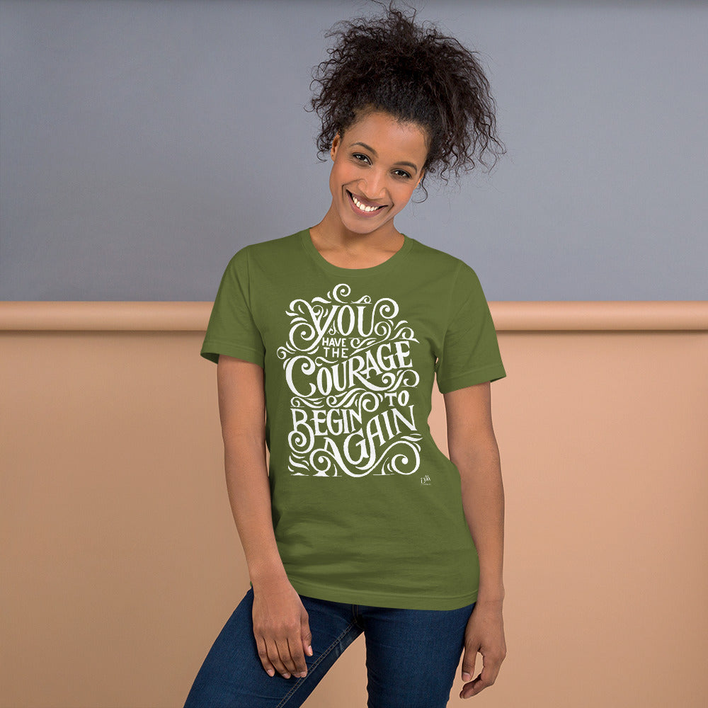 Woman wearing a green t-shirt with motivational quote on a plain background