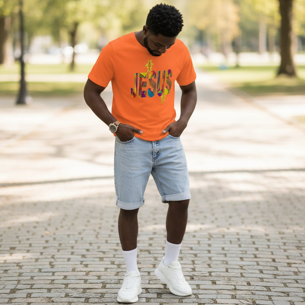 Person wearing an orange 'Jesus' t-shirt in a park setting