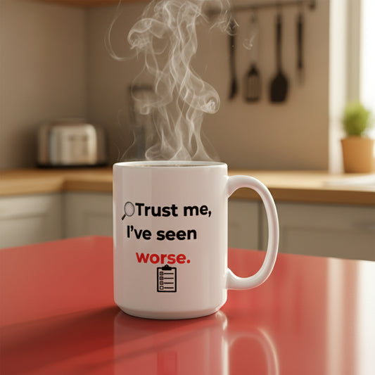 White mug with text 'Trust me, I've seen worse.' on a red surface in a kitchen setting.