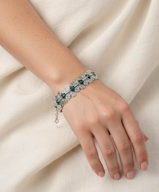 Woman wearing butterfly charm bracelet with crystal briolette beads – handmade accessory