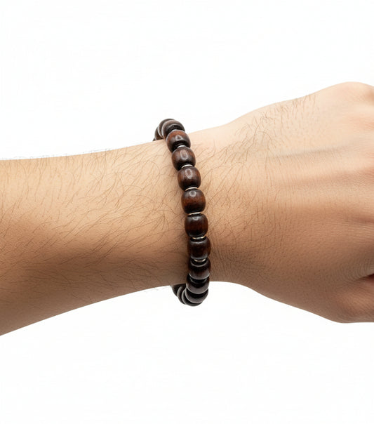Person wearing coconut brown wood barrel bracelet – natural unisex handmade accessory