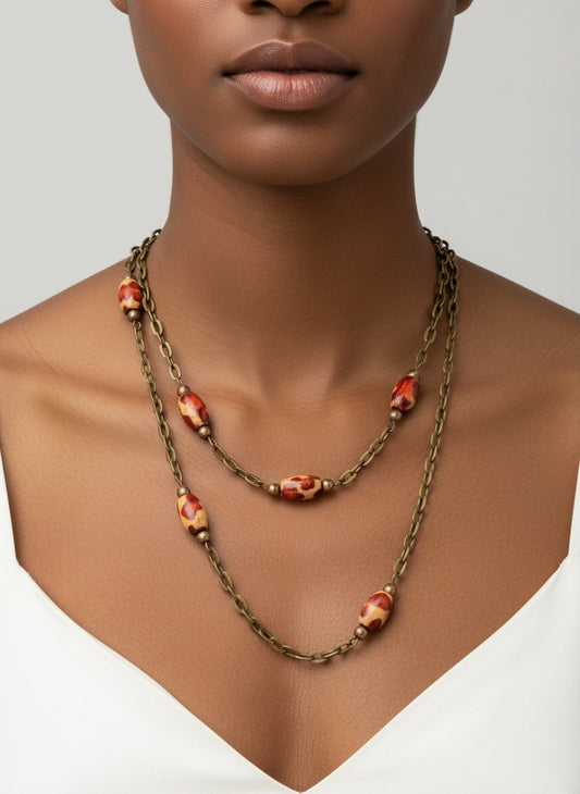 Necklace with red and gold beads on a neutral background