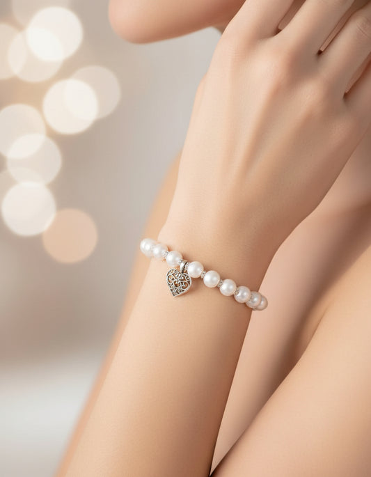 Woman wearing pearl bracelet with heart charm – cute elegant handmade bracelet