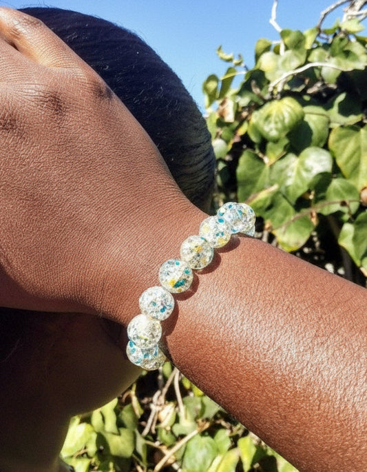 Woman wearing crackle bead bracelet in pink or aqua – vibrant handmade accessory
