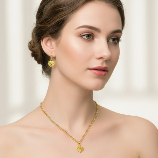 A woman wearing a gold heart necklace and matching gold heart earrings