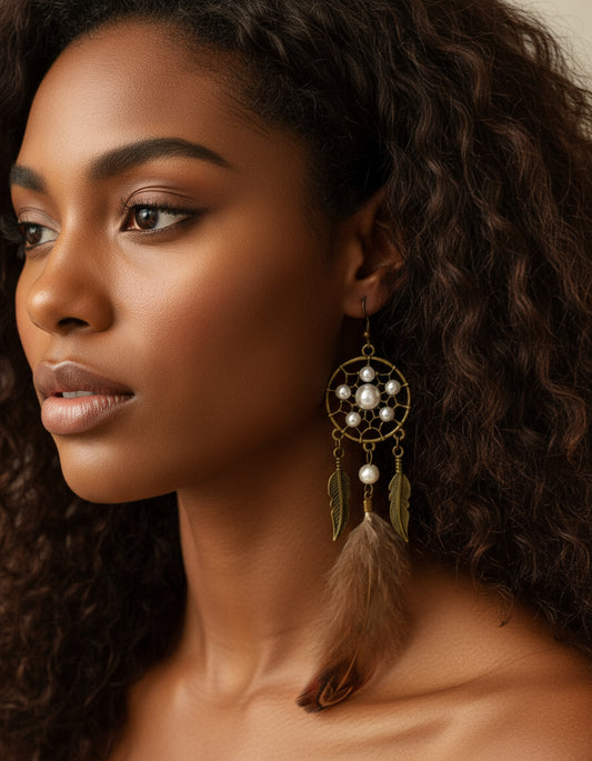 A woman wearing handmade pheasant feather dream catcher earrings with pearl beads