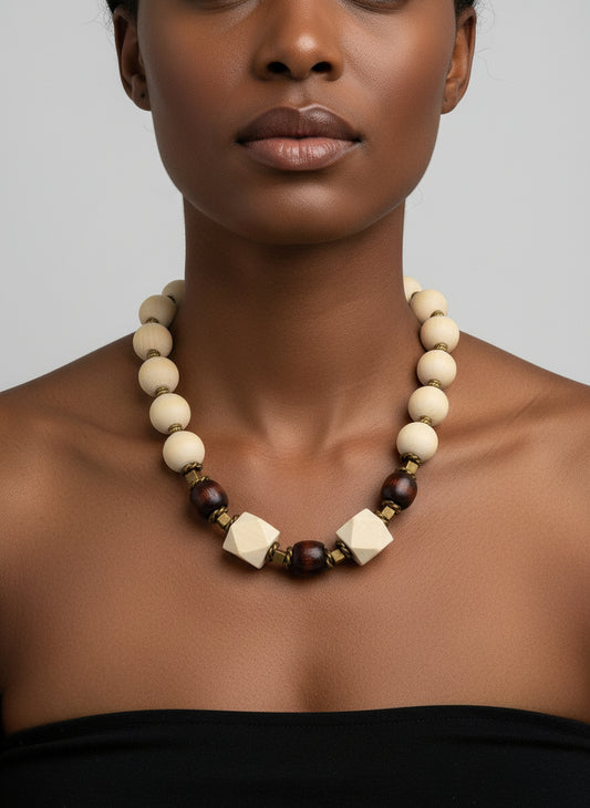 A woman wearing a chunky natural wood bead necklace with bronze spacers and 23-inch drape