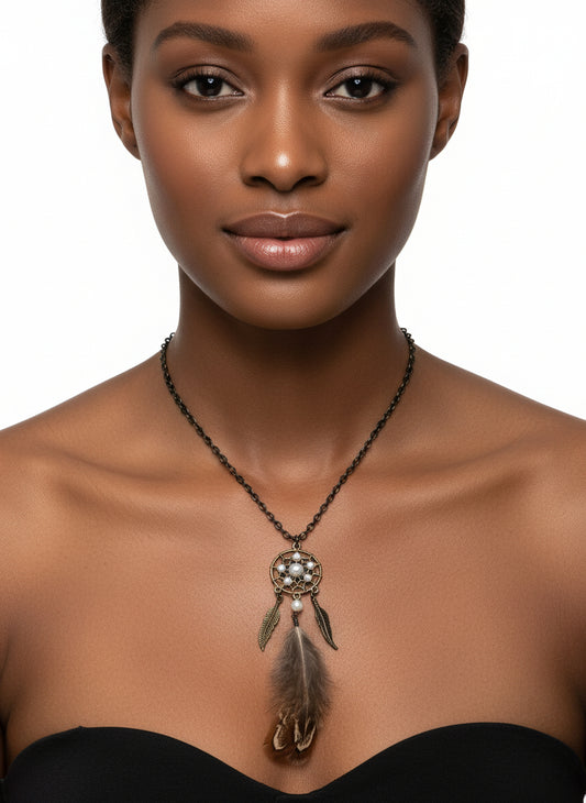 A woman wearing a feathered dream catcher necklace with pheasant feathers and pearl beads